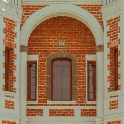 Detailed close-up of an 1898 brick facade with arches in Puebla, Mexico.